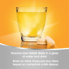 Tablets poured with glass of water showing effervescent action