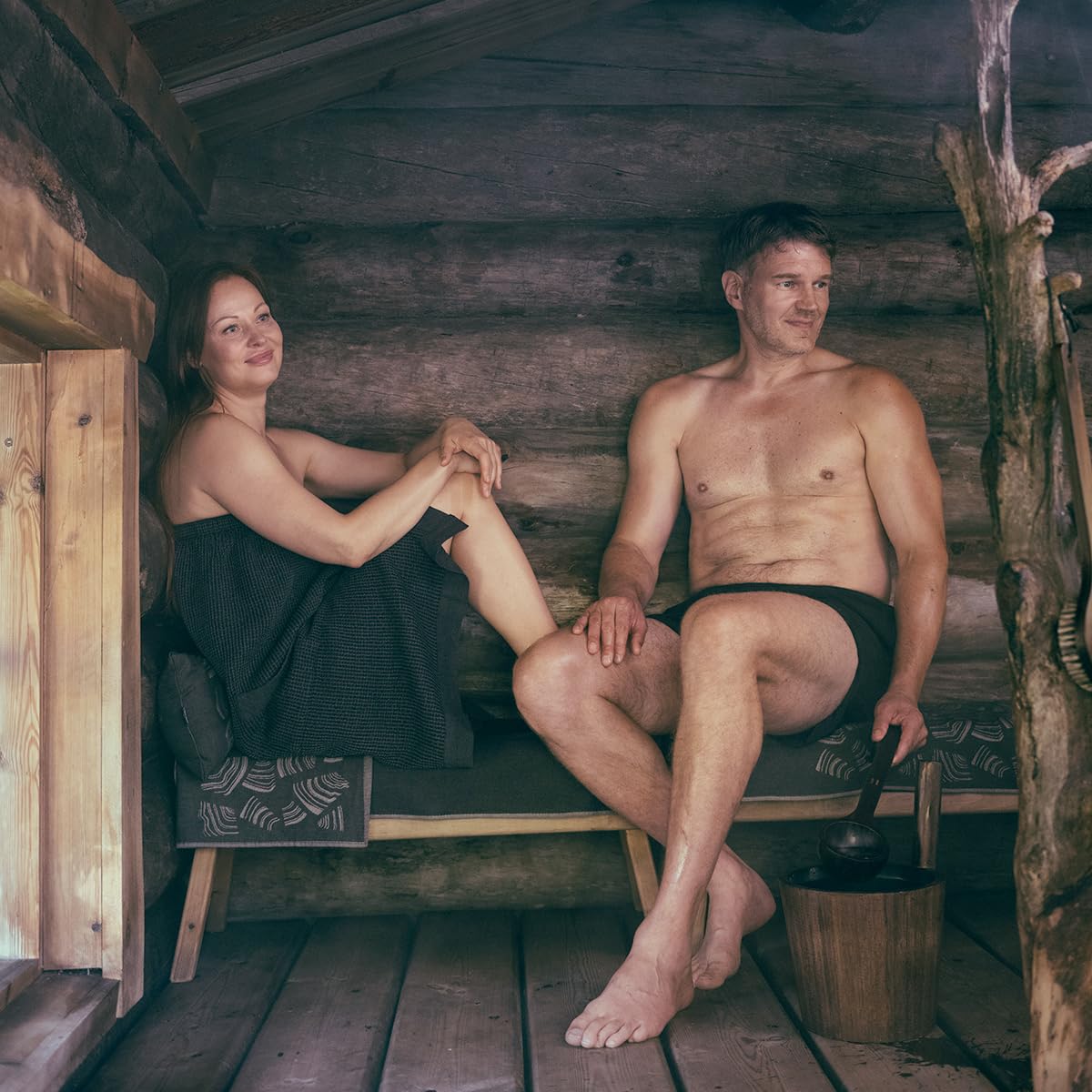 Pouring water to release birch aroma in sauna