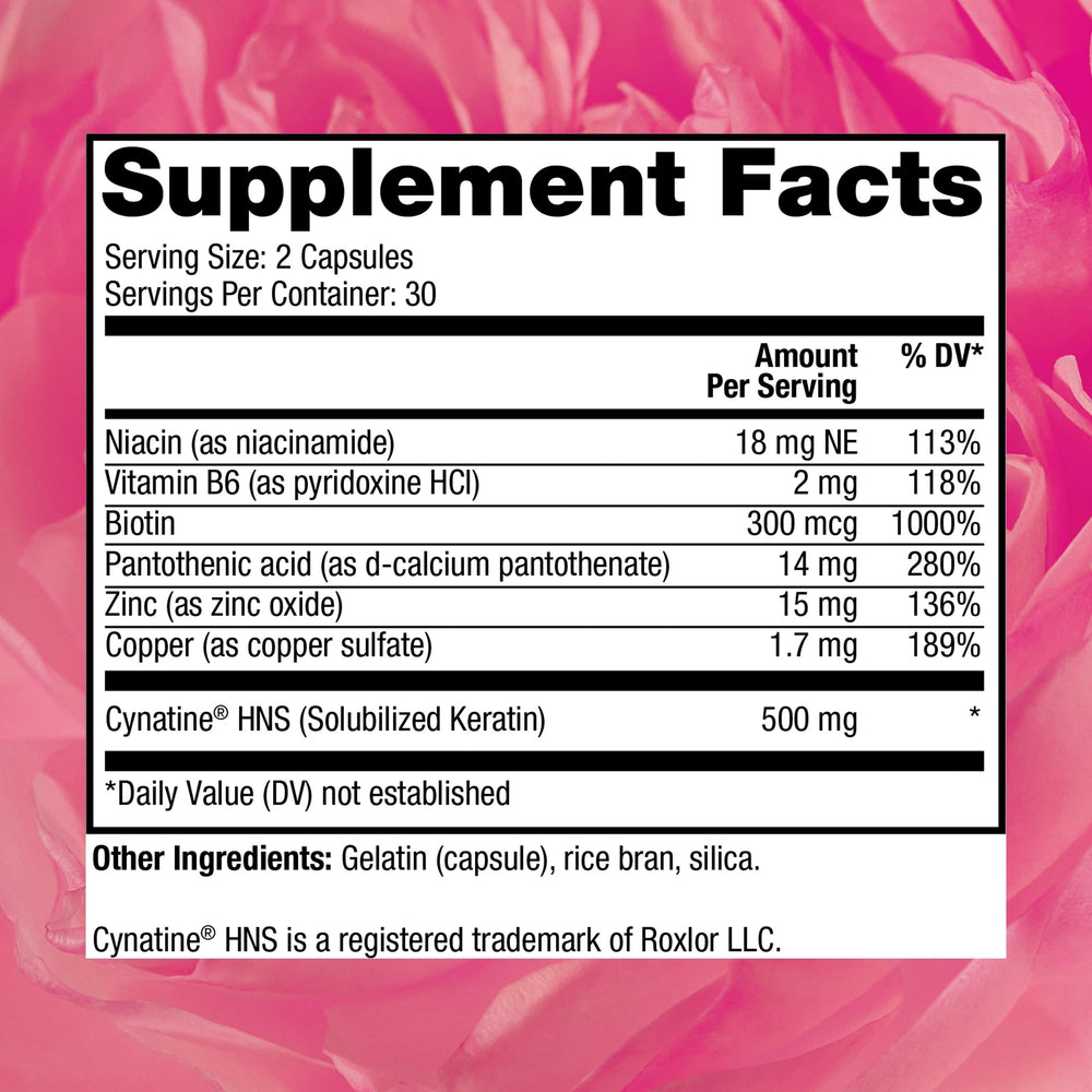 Hair growth supplement capsules arranged on a white surface