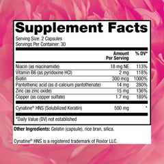 Hair growth supplement capsules arranged on a white surface