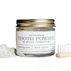 Revive Homestead Hydroxyapatite Tooth Powder in amber glass jar with erythritol