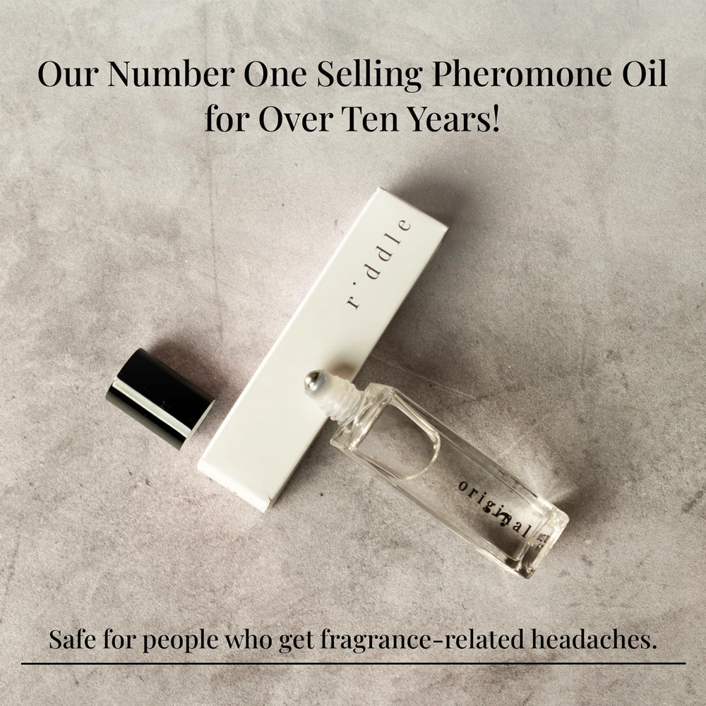 Woman applying Riddle Original Roll-On perfume