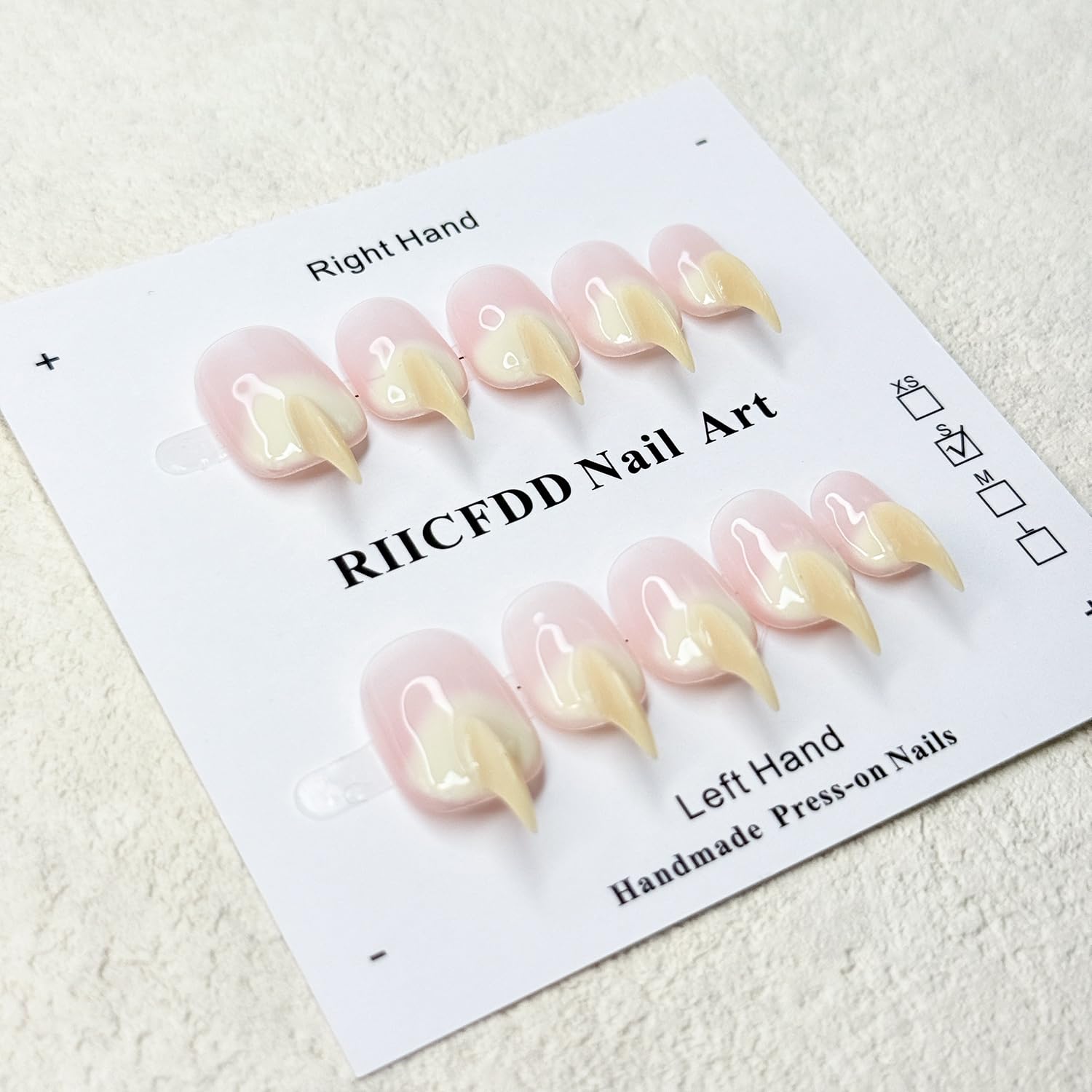 RIICFDD beige curved stiletto cat-claw nails on tray for durable wear.