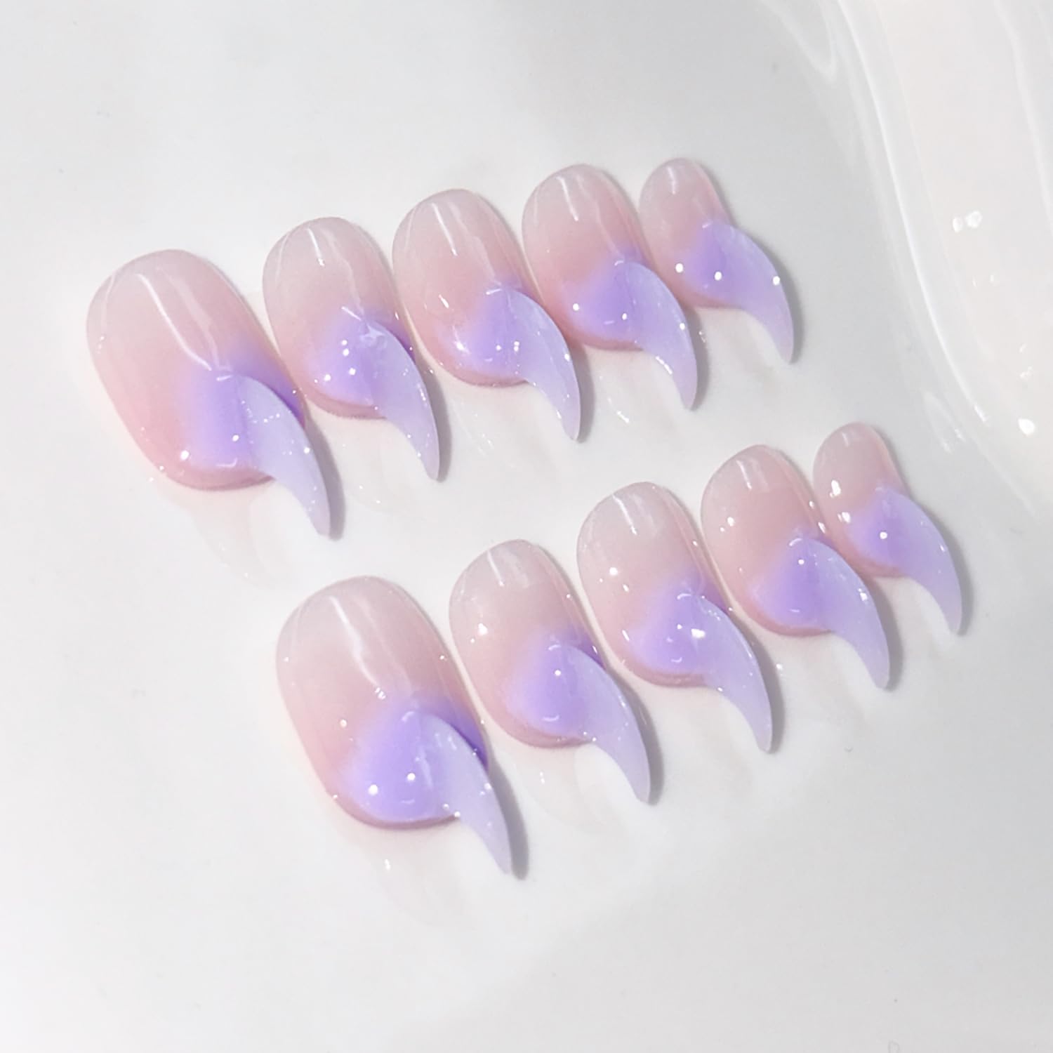 RIICFDD curved press-on nails in stiletto cat-claw shape for a salon-grade manicure.