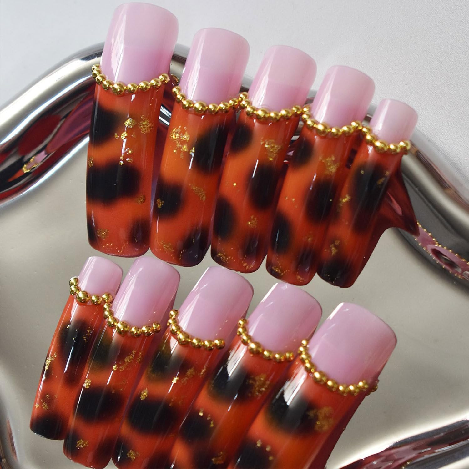 RIICFDD leopard-print French-tip nails on hand for dramatic, versatile fall look.