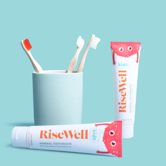 Close-up of Risewell Kids toothpaste texture showing white remineralizing paste