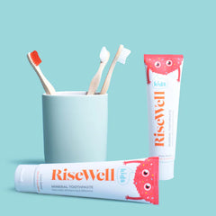Close-up of Risewell Kids toothpaste texture showing white remineralizing paste