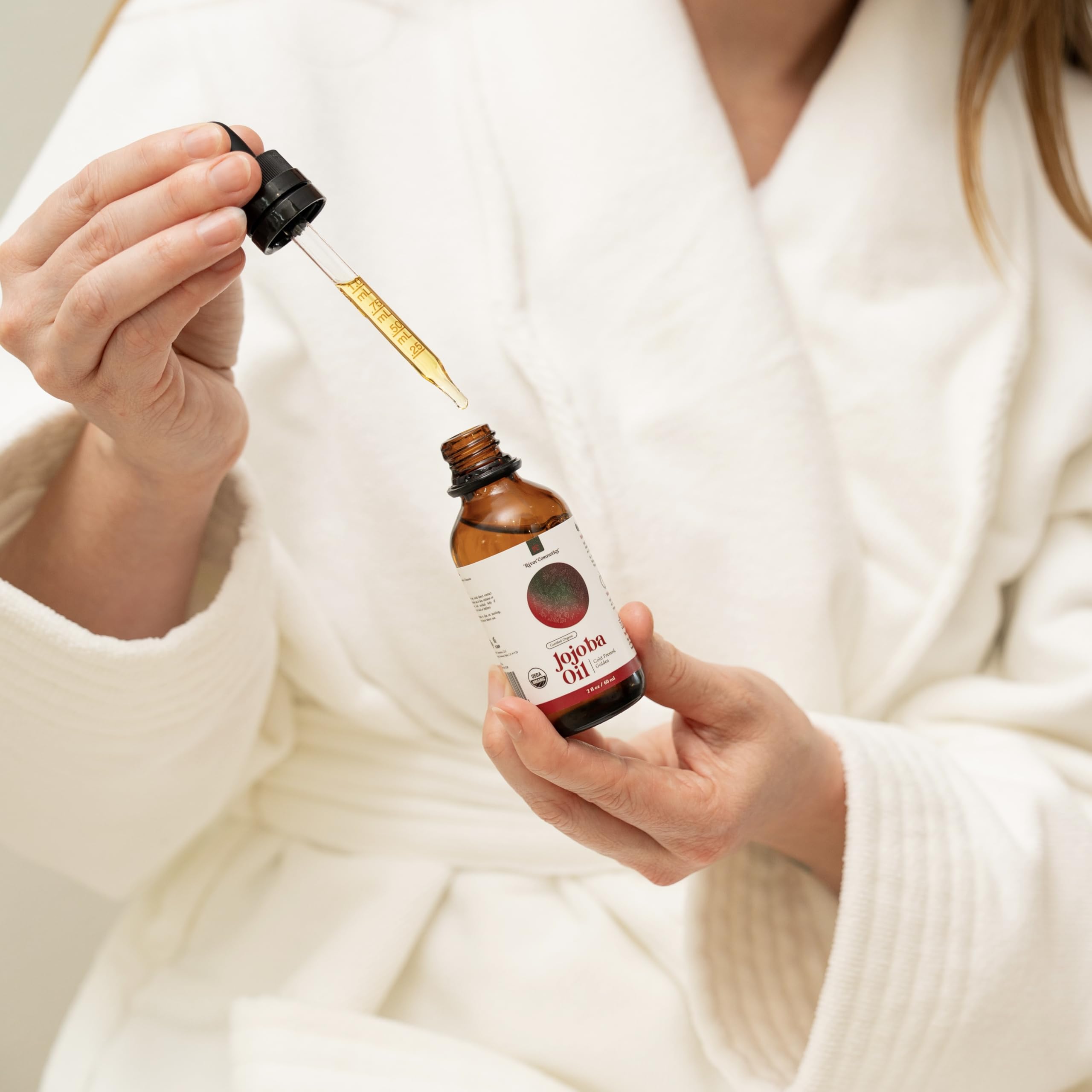 River Cosmetics Jojoba Oil on hair nourishes scalp and adds natural shine.