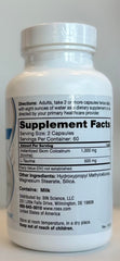 Capsules poured next to a measuring spoon