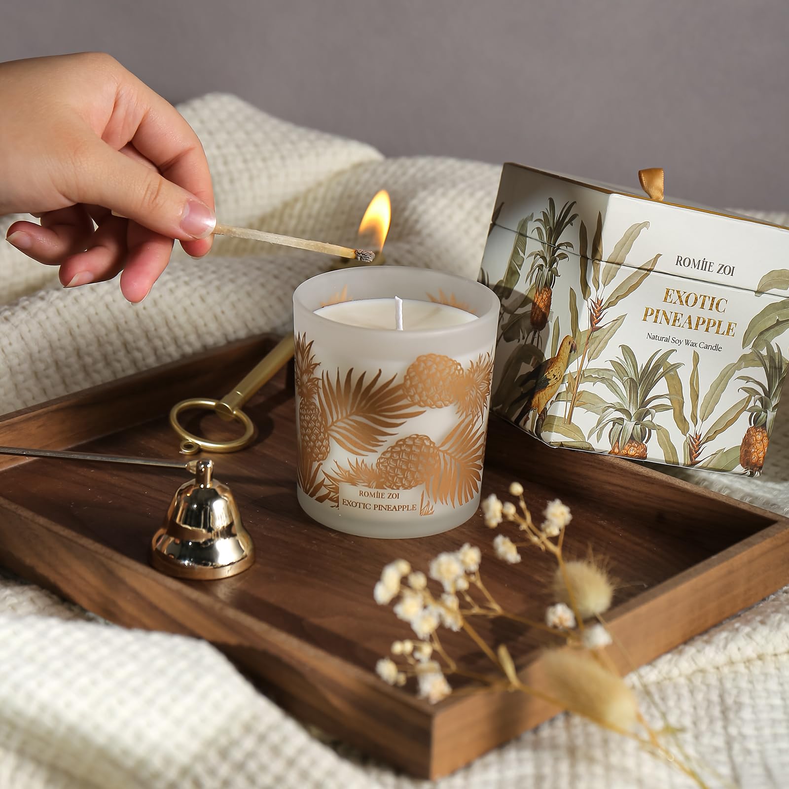 ROMIIE ZOI Pineapple candle in a cozy home setting