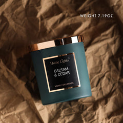 Candle with silky color glass and rosegold lid featuring balsam cedar scent