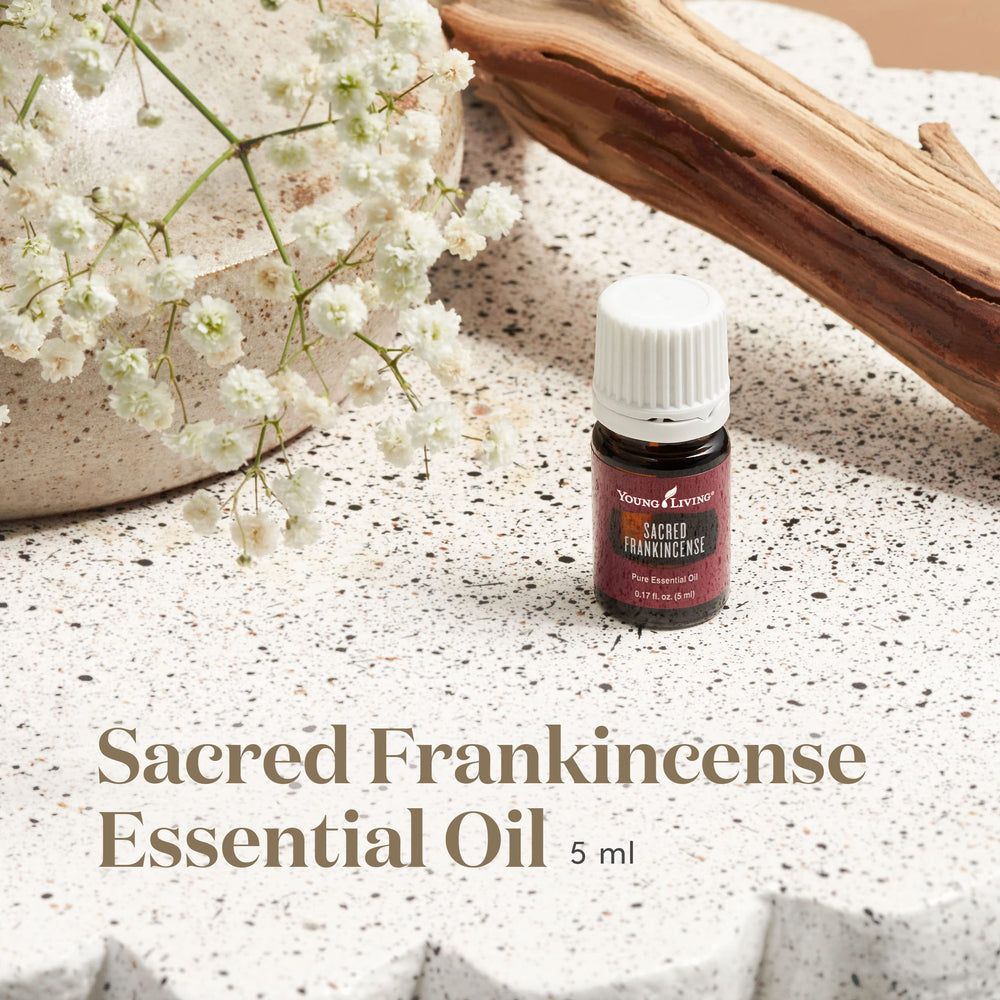 Close-up of dropper releasing sacred frankincense oil