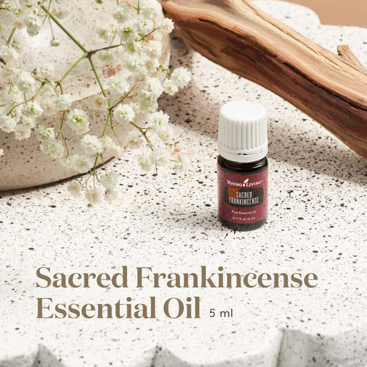 Close-up of dropper releasing sacred frankincense oil