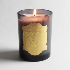 Side view of the Saint Anthony candle highlighting bergamot and oud fragrance