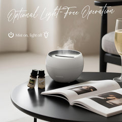 White 150ml ultrasonic aroma diffuser emitting mist in living room