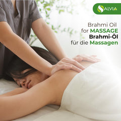 Dropper dispensing Brahmi oil onto a white surface