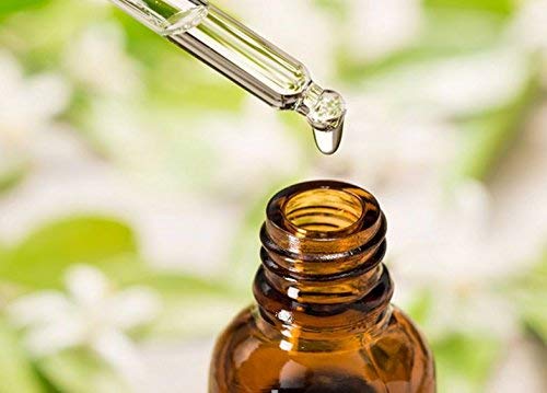 Neroli essential oil in amber bottle, side view
