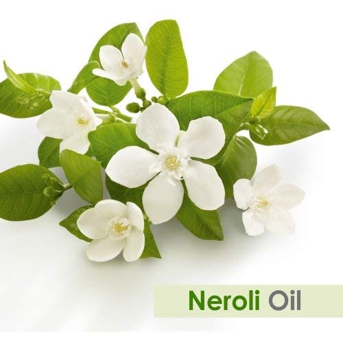 Dropper dispensing Neroli essential oil from amber bottle