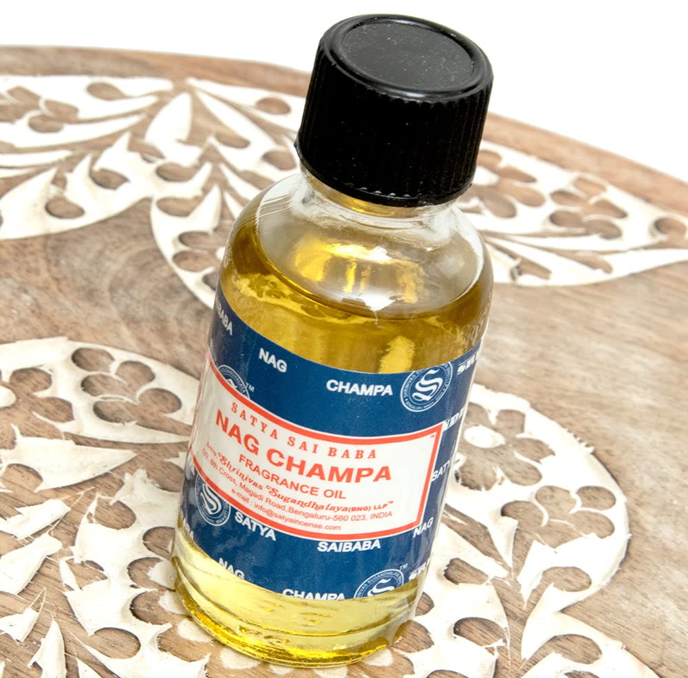 Diffuser releasing Nag Champa aroma with 30 ml bottle nearby