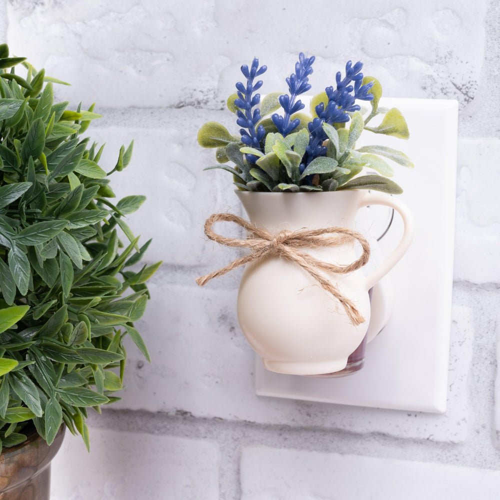 Scent Charm wall-plug diffuser installed in a bedroom