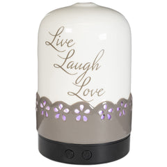 ScentSationals Sentiments diffuser ivory-tan on table enhances room ambiance for relaxation.