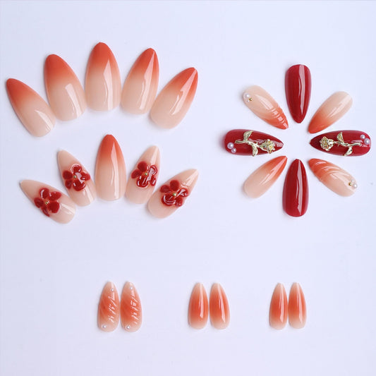 SEENEEY almond press-on nails with red gold flowers design in a ready-to-wear setup.