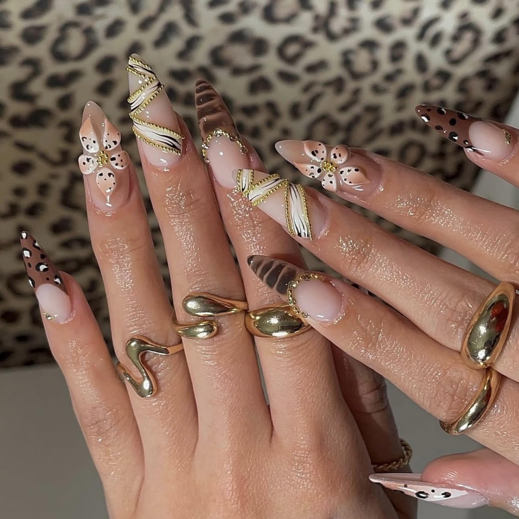 SEENEEY long almond press-on nails with brown floral and gold charms for elegant at-home manicures.