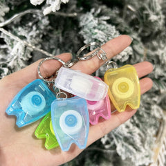 Travel-friendly dental floss keychain in hand