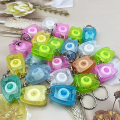 Assorted colors tooth-shaped floss keychains concept