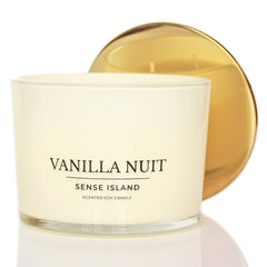 Sense Island Vanilla Nuit 3-Wick candle in a cozy room promotes relaxing ambiance.