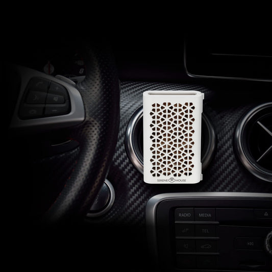 Serene House Puccini car vent clip white on dashboard for calming scents.