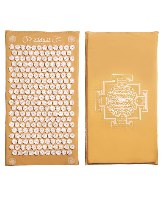 ShaktiMat Classic Acupressure Mat in yellow with light intensity on a white surface
