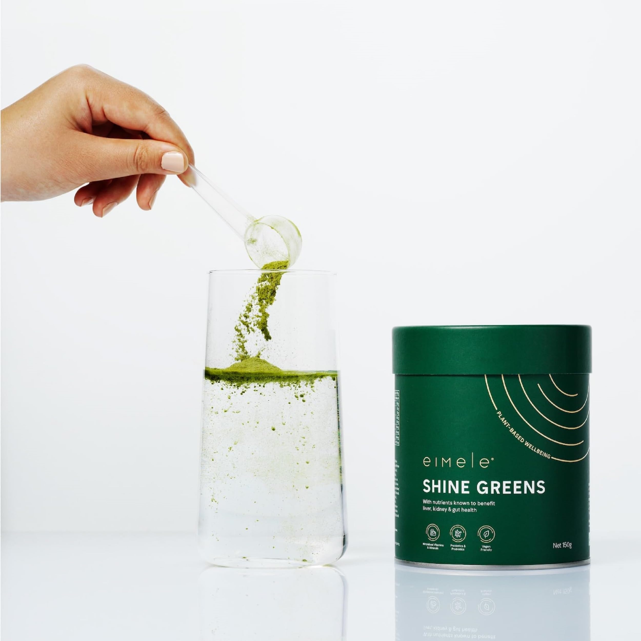 Scoop of Shine Greens powder being prepared