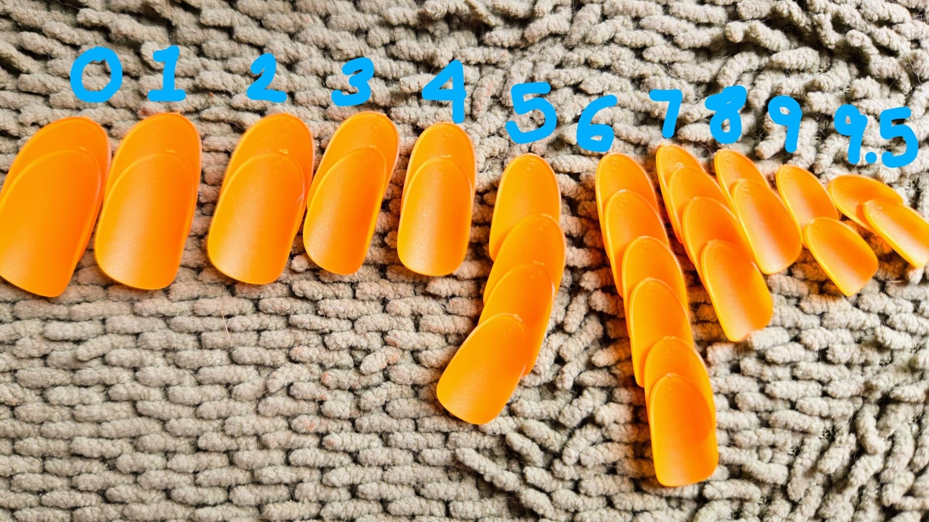 Shoindary orange press-on nails close-up showcasing glossy finish