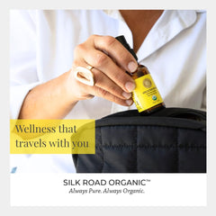Applying Silk Road Helichrysum spray to skin after a shower.