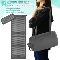 Person meditating on the acupressure mat in a calm space