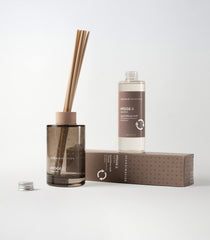 Glass diffuser vase with beechwood ring and decorative reeds