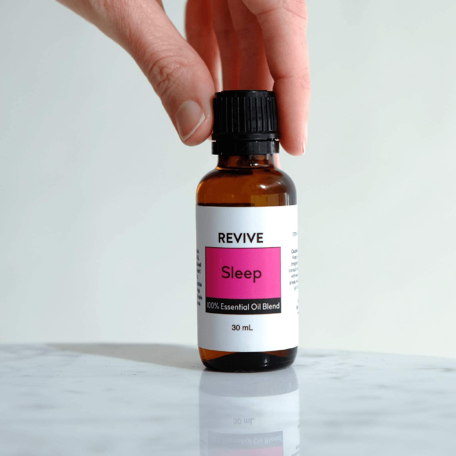 Person diffusing Revive Sleep oil blend at night