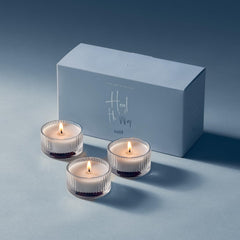 Snif Heal The Way Votive unlit candle sits on wood, ready for a calming ritual.