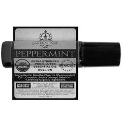 Travel-size Sniffelixir peppermint roll-on beside skincare products