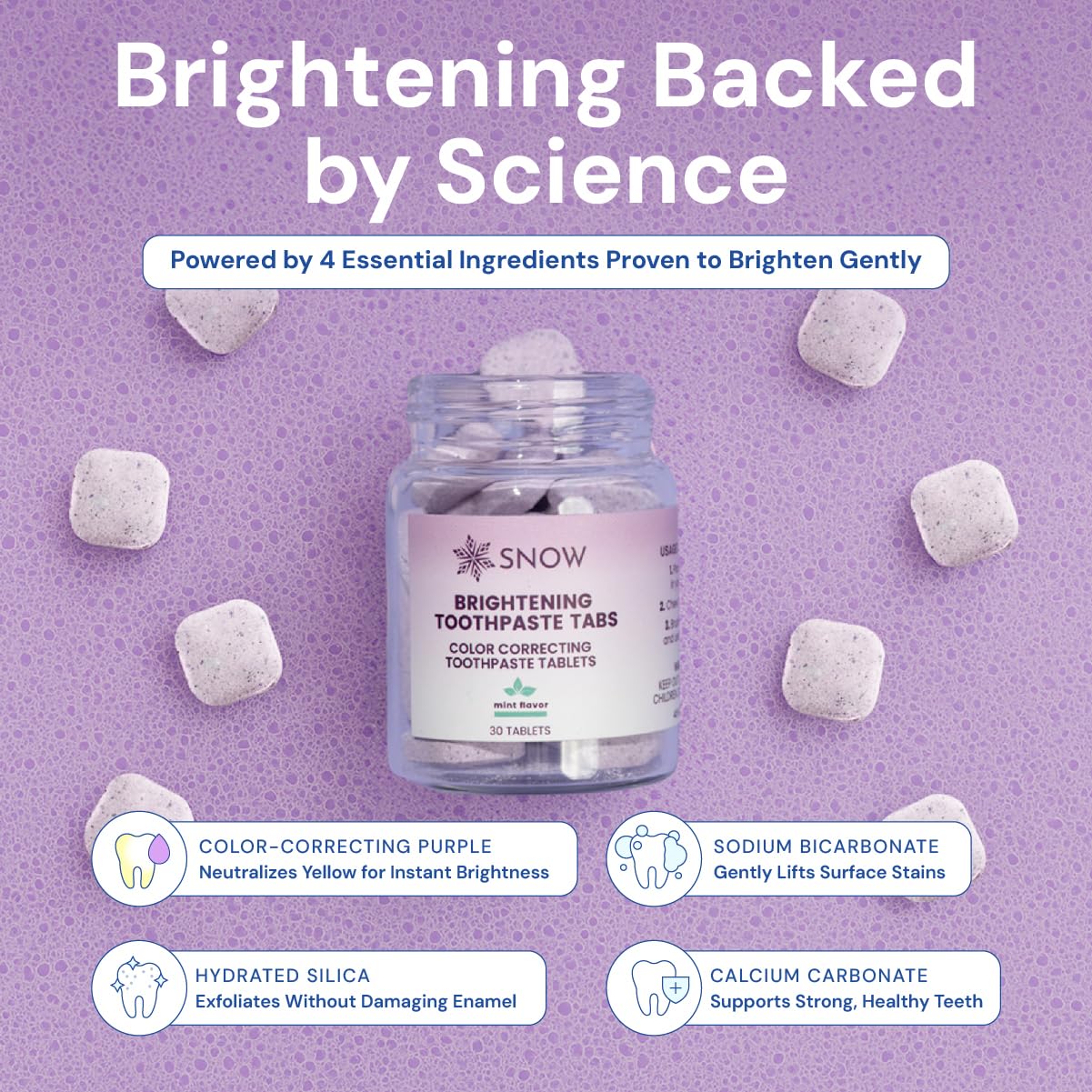 Close-up of biting a SNOW whitening toothpaste tablet