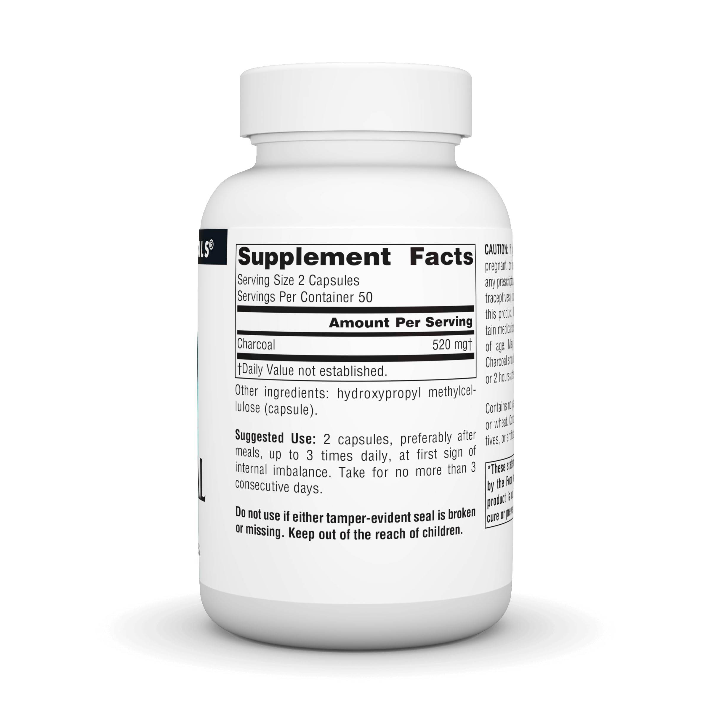 Activated charcoal capsules laid out on white background