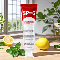 Toothpaste with mint leaves and toothbrush on bathroom counter