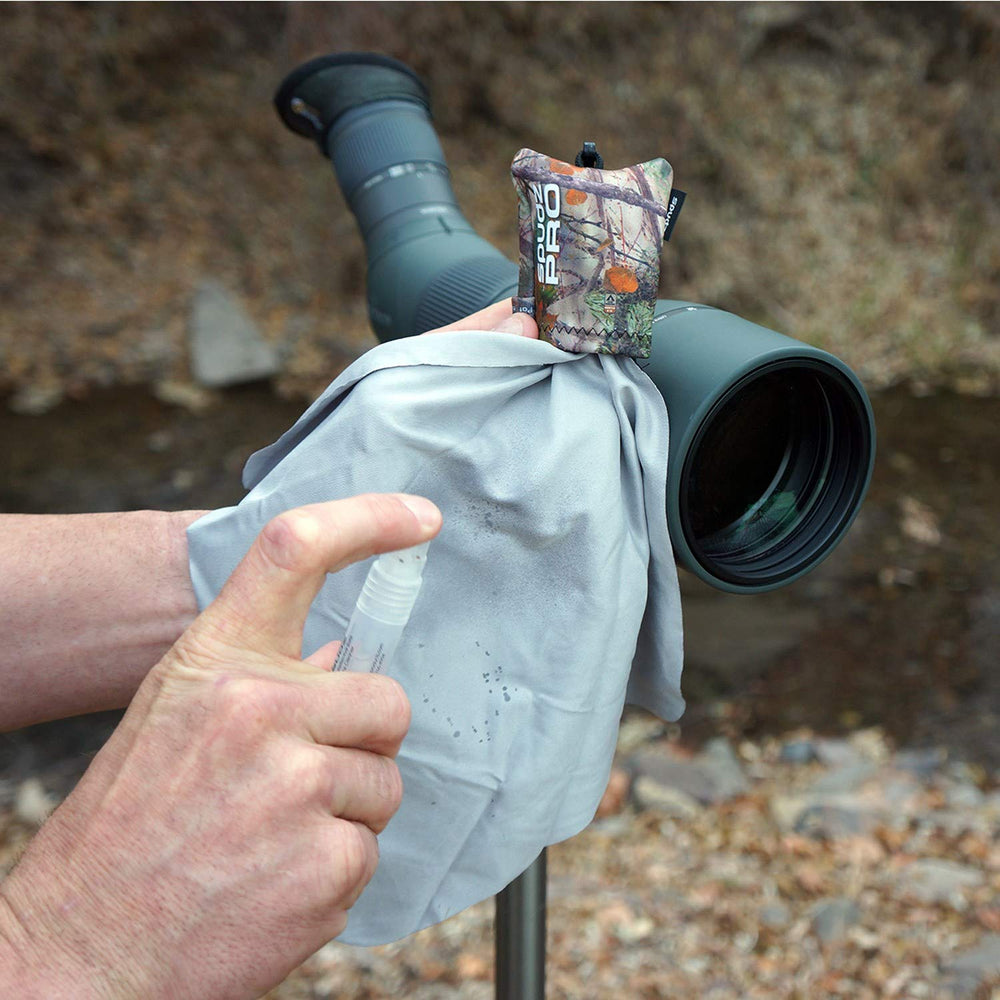 Hands using SPUDZ Pro to wipe a lens or smartphone display