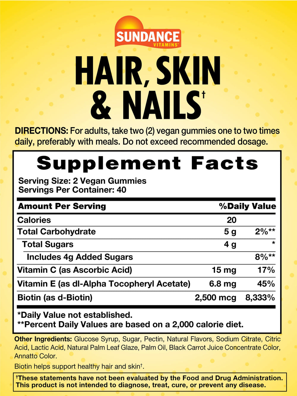 Close-up of fruit-flavored gummies labeled for hair, skin, and nails with vitamins C and E.