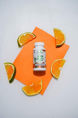 Lifestyle shot of Sundhed Liposomal Vitamin C capsules with a glass of water