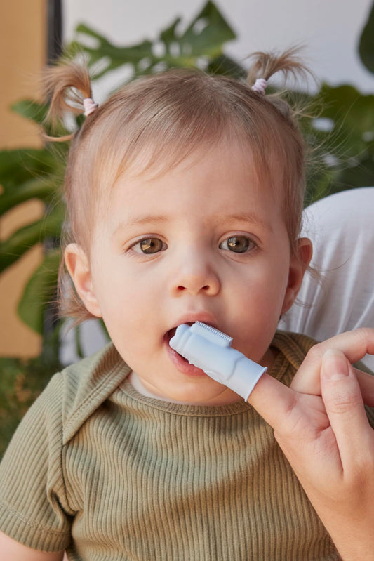 Finger brush with built-in bite block protecting parents' fingers