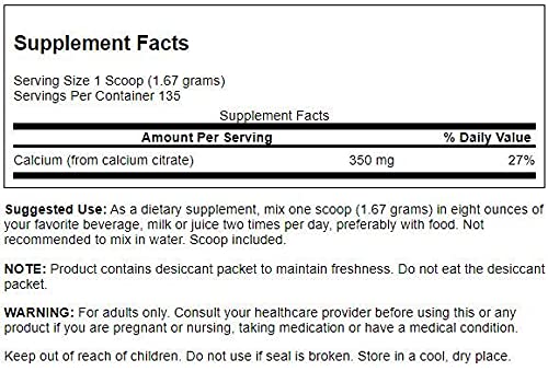 Scooper with calcium citrate powder in a measuring cup
