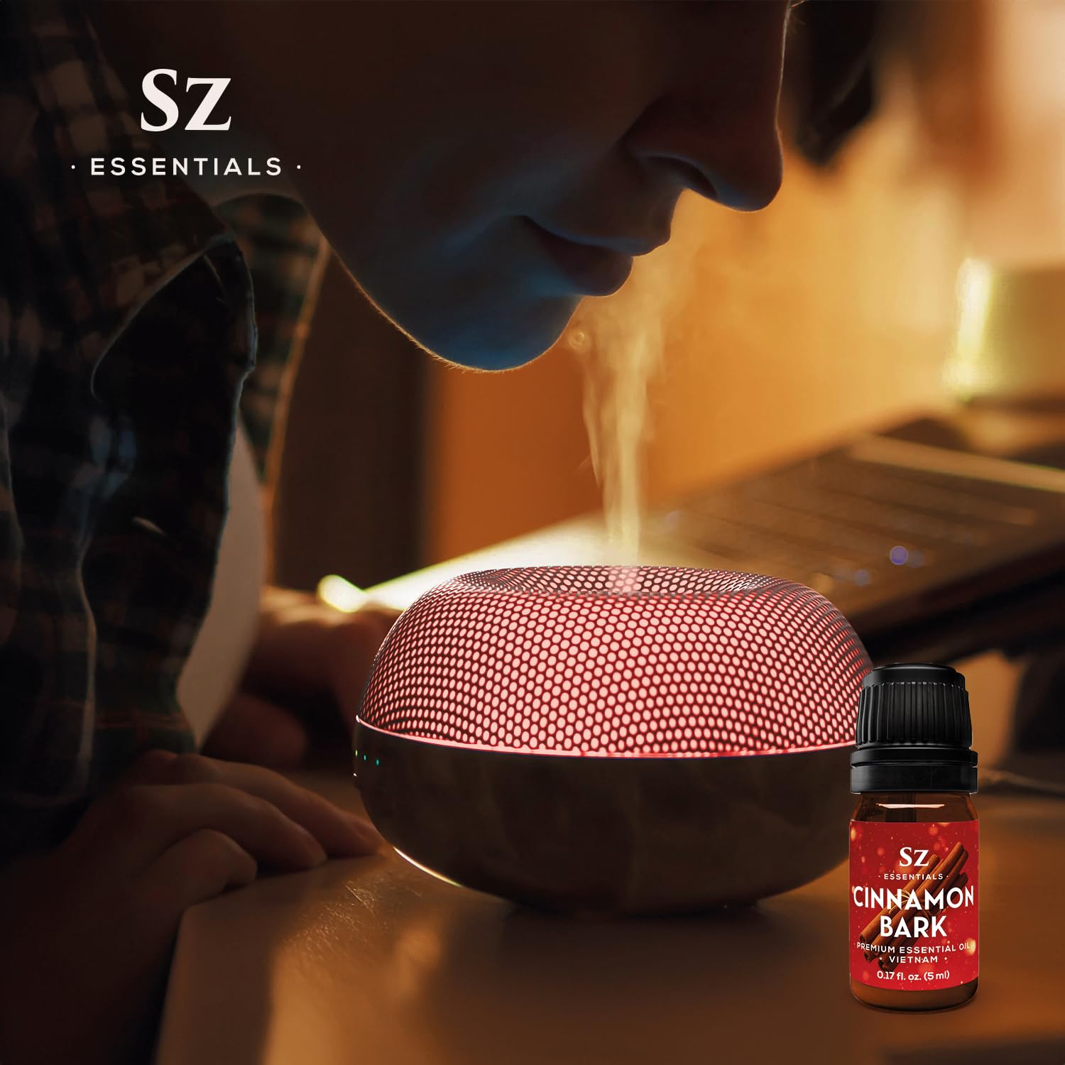 Cinnamon sticks beside a bottle of Cinnamon Bark Essential Oil