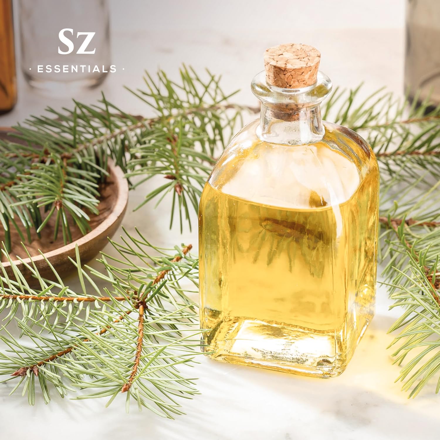 Fresh forest-inspired aroma with Silver Pine essential oil in wood background